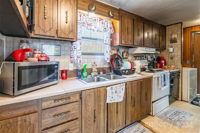 kitchen with tasteful backsplash, sink, and white electric range