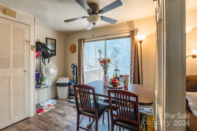 dining room with ceiling fan, wood-type flooring, and a textured ceiling