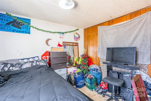 bedroom featuring wooden walls