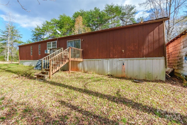 rear view of property with a lawn