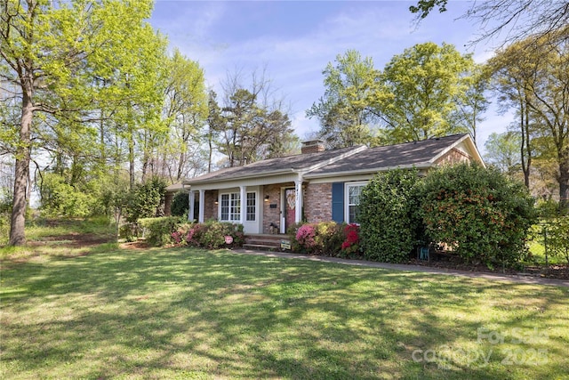 5431 Park Rd, Charlotte, NC 28209 - view of front of house featuring brick siding, a chimney, and a front lawn