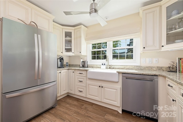 5431 Park Rd, Charlotte, NC 28209 - kitchen featuring a ceiling fan, light stone countertops, dark wood-type flooring, stainless steel appliances, and a sink