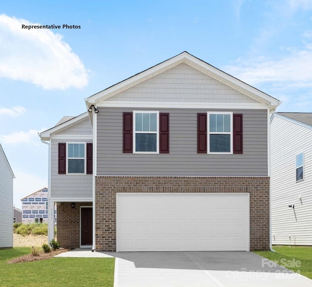 view of front facade featuring a garage and a front lawn