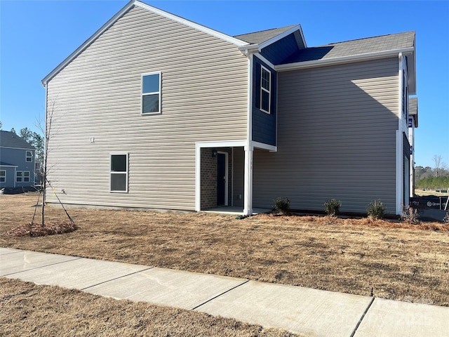 rear view of house featuring a lawn