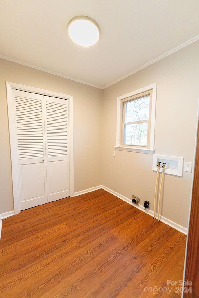 washroom featuring crown molding, hookup for a washing machine, and wood-type flooring