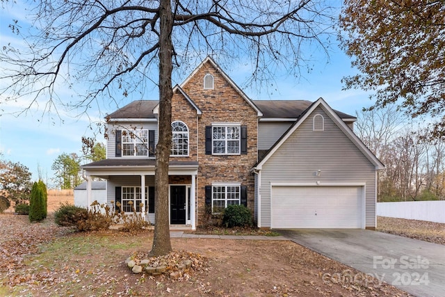 view of front facade featuring a porch and a garage