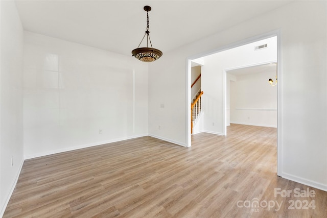 1805 Lexington Ave, Monroe, NC 28112 - unfurnished room featuring stairs, light wood-type flooring, and baseboards