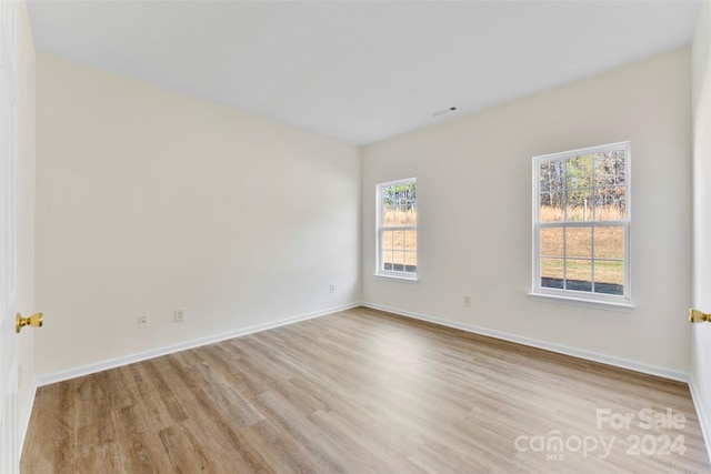 unfurnished room featuring light wood-type flooring