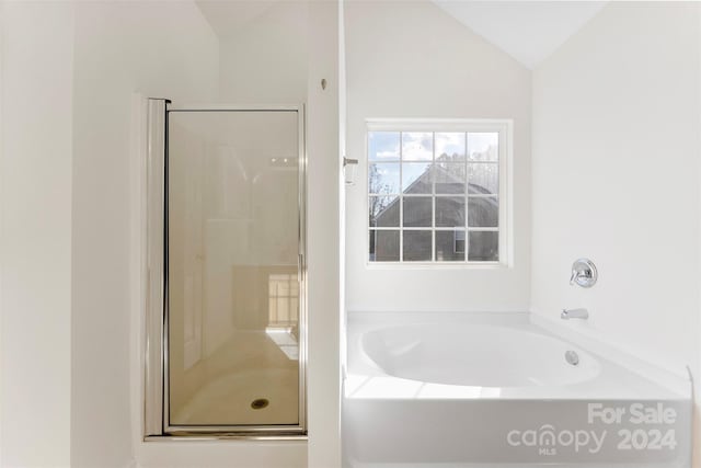 bathroom with separate shower and tub and lofted ceiling