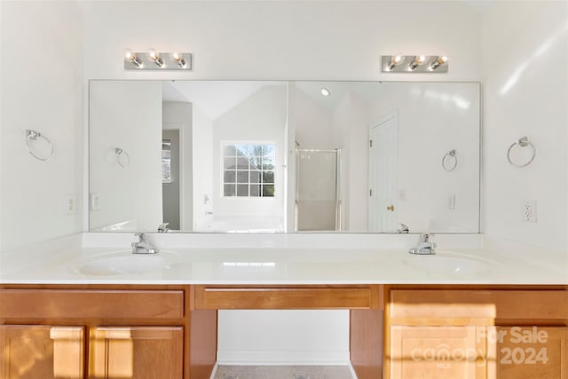 bathroom featuring vanity and an enclosed shower