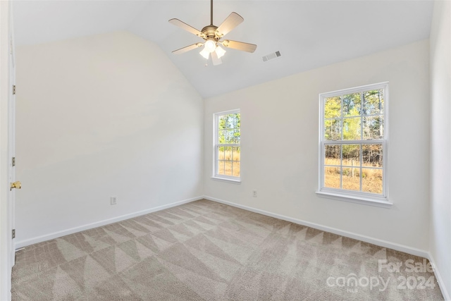 carpeted spare room featuring ceiling fan and lofted ceiling