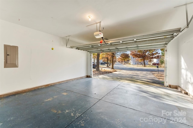 garage with electric panel and a garage door opener