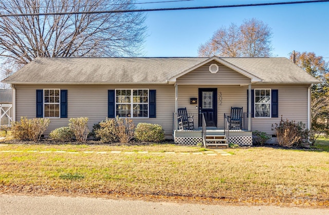 single story home with a porch and a front lawn