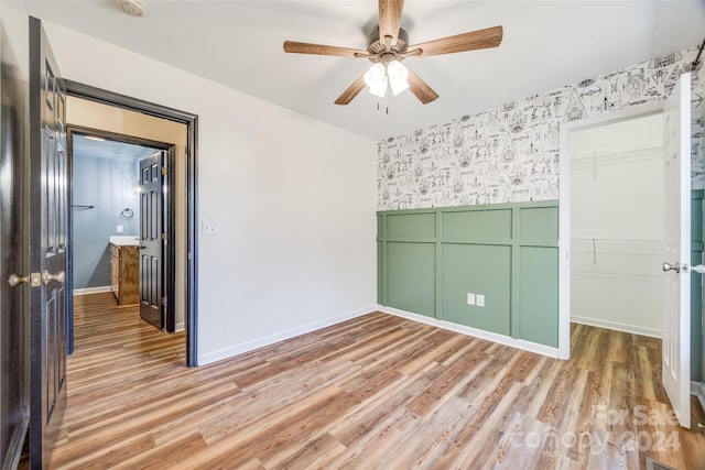 unfurnished room featuring ceiling fan and light hardwood / wood-style floors