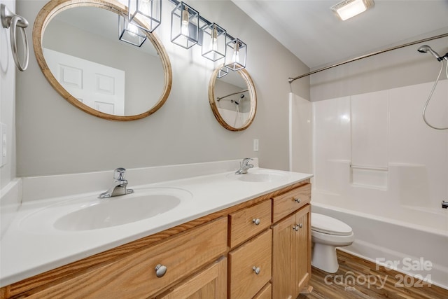 full bathroom featuring vanity, wood-type flooring,  shower combination, and toilet