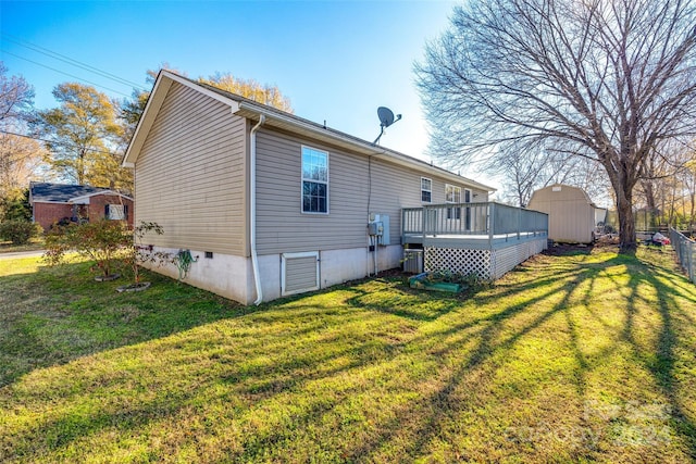 rear view of property featuring a yard and a deck