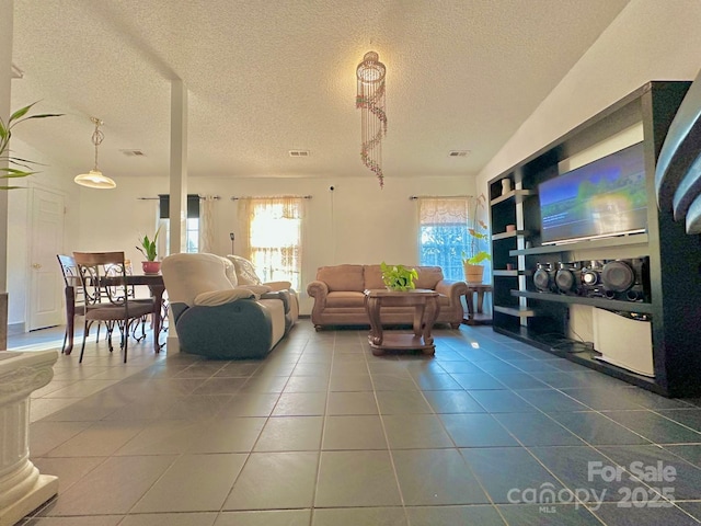 8430 Stoneman Pl, Charlotte, NC 28217 - living area with tile patterned flooring, visible vents, and a textured ceiling