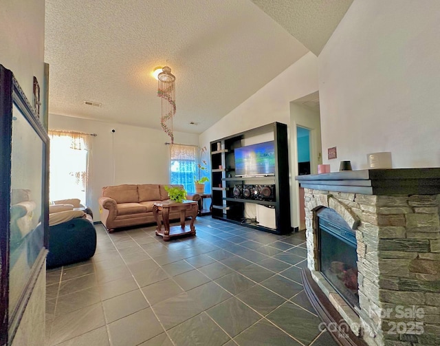 8430 Stoneman Pl, Charlotte, NC 28217 - living room with vaulted ceiling, a fireplace, dark tile patterned floors, and a textured ceiling