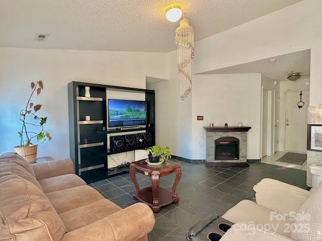 8430 Stoneman Pl, Charlotte, NC 28217 - tiled living area with lofted ceiling, visible vents, a stone fireplace, and a textured ceiling