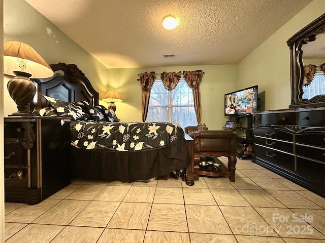 8430 Stoneman Pl, Charlotte, NC 28217 - bedroom featuring a textured ceiling, light tile patterned floors, and visible vents