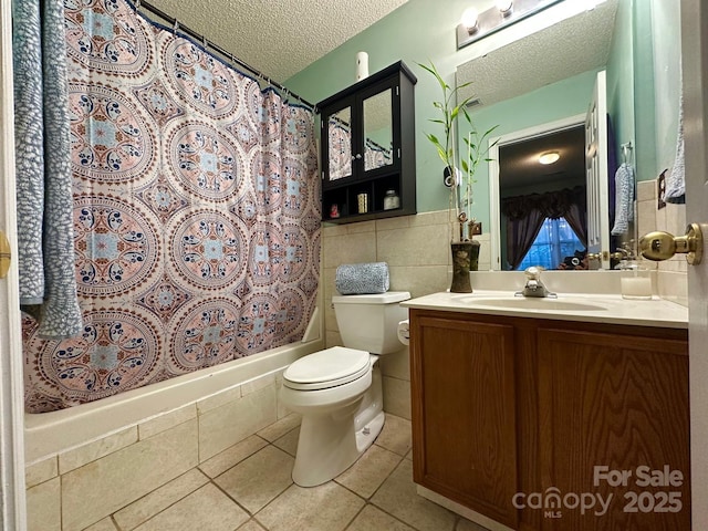 8430 Stoneman Pl, Charlotte, NC 28217 - full bath with tile walls, toilet, a textured ceiling, vanity, and tile patterned flooring