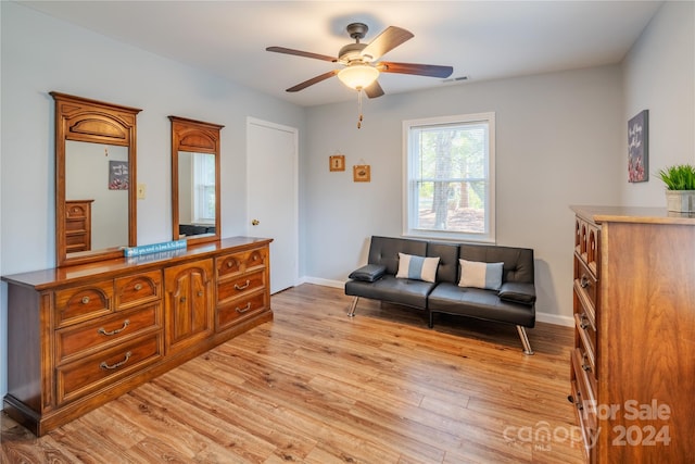 sitting room with ceiling fan and light hardwood / wood-style flooring