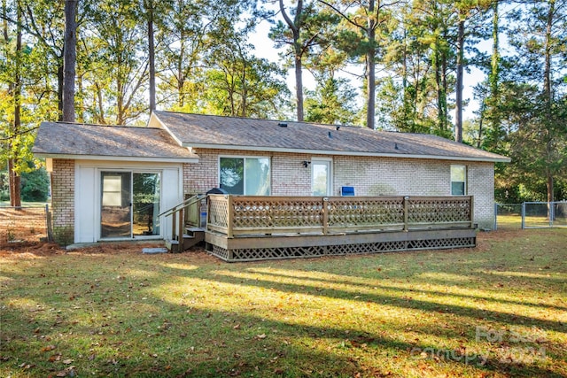 back of house featuring a yard and a wooden deck