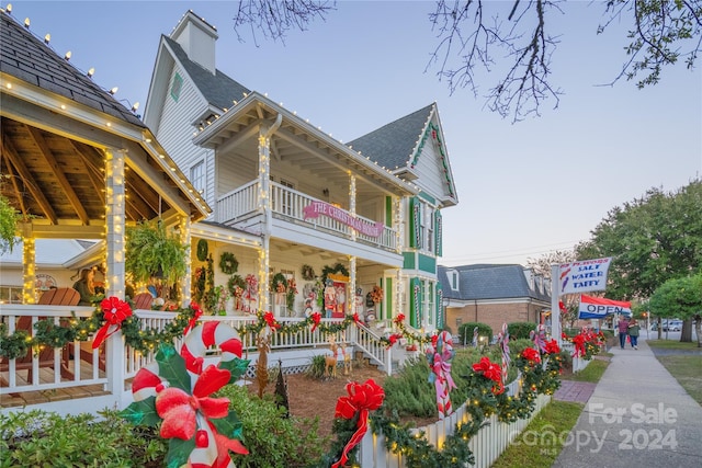 view of front of home featuring a porch and a balcony