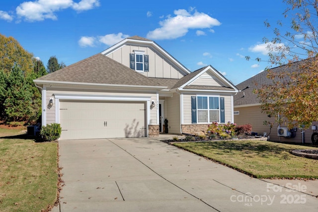 craftsman inspired home with a garage and a front yard