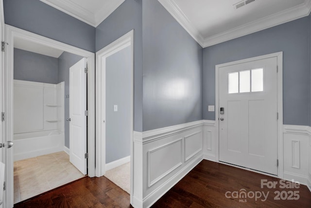 entrance foyer featuring crown molding and hardwood / wood-style floors