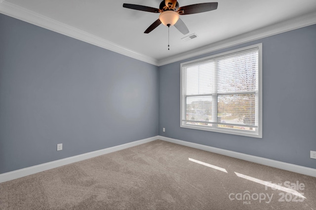 empty room with ornamental molding, ceiling fan, and carpet flooring