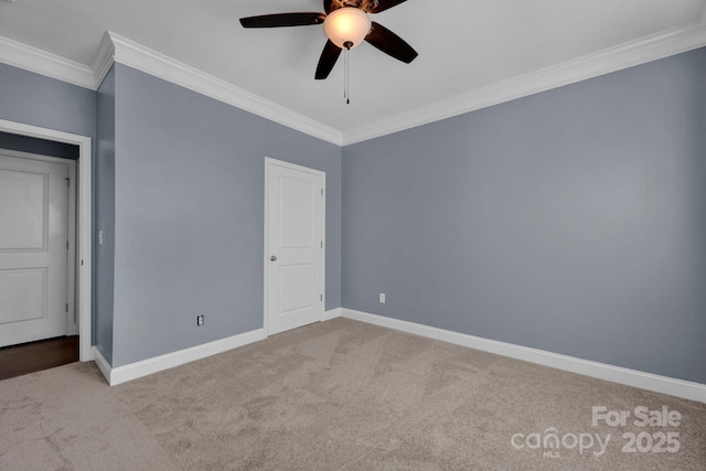 unfurnished bedroom featuring ornamental molding, carpet, and ceiling fan