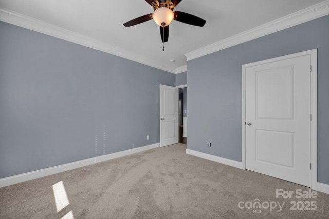 unfurnished bedroom with ornamental molding, light colored carpet, and ceiling fan