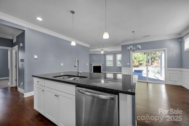 kitchen with white cabinetry, dishwasher, sink, dark stone countertops, and a kitchen island with sink