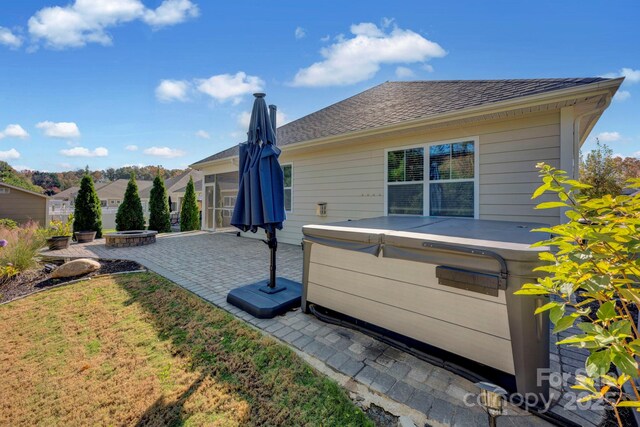 rear view of property featuring a yard and a patio area