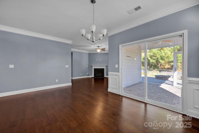 unfurnished living room with ornamental molding, dark hardwood / wood-style flooring, and ceiling fan with notable chandelier