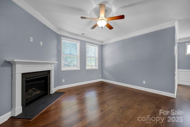 unfurnished living room featuring dark wood-type flooring, ornamental molding, and a wealth of natural light