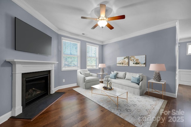 living room featuring ceiling fan, ornamental molding, and dark hardwood / wood-style flooring