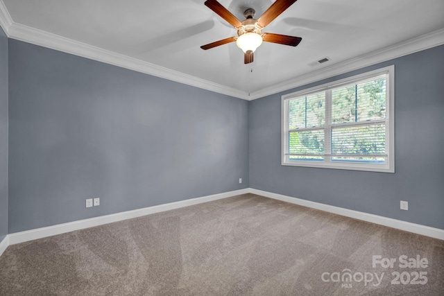 empty room featuring crown molding, ceiling fan, and carpet