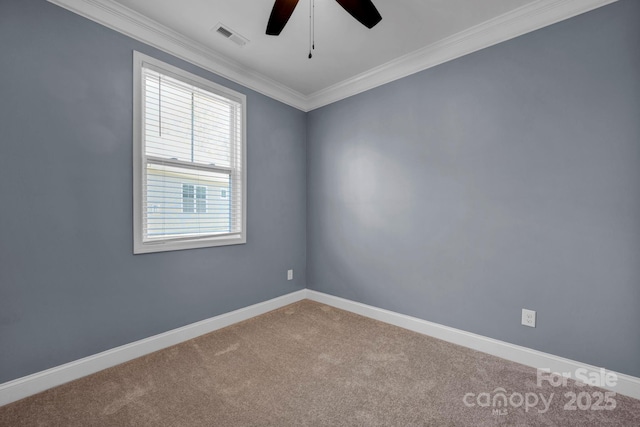 empty room featuring crown molding, carpet flooring, and ceiling fan