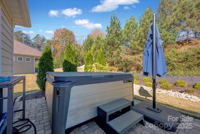 view of patio / terrace with a hot tub