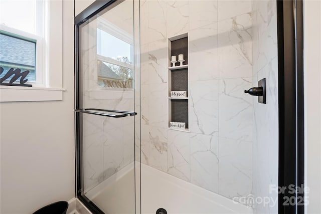 bathroom with a shower with shower door