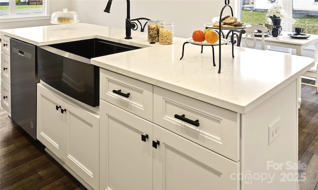 kitchen with light stone countertops, stainless steel dishwasher, dark hardwood / wood-style flooring, white cabinets, and sink