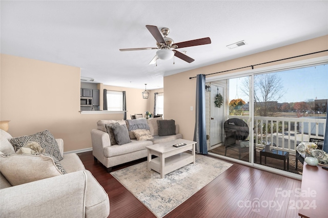 living room featuring dark hardwood / wood-style floors and ceiling fan