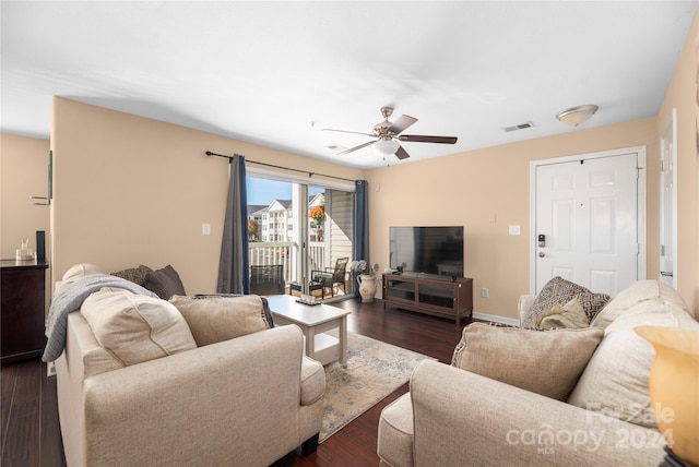 living room with dark hardwood / wood-style floors and ceiling fan