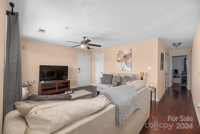 living room with ceiling fan and dark wood-type flooring