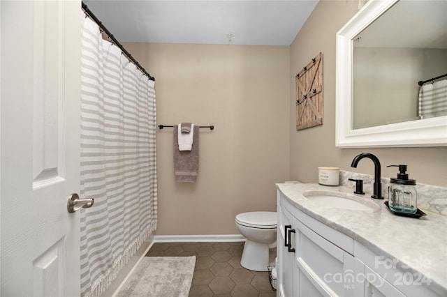 bathroom featuring tile patterned floors, vanity, and toilet