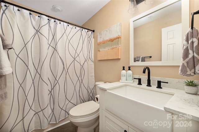 bathroom featuring tile patterned floors, vanity, and toilet