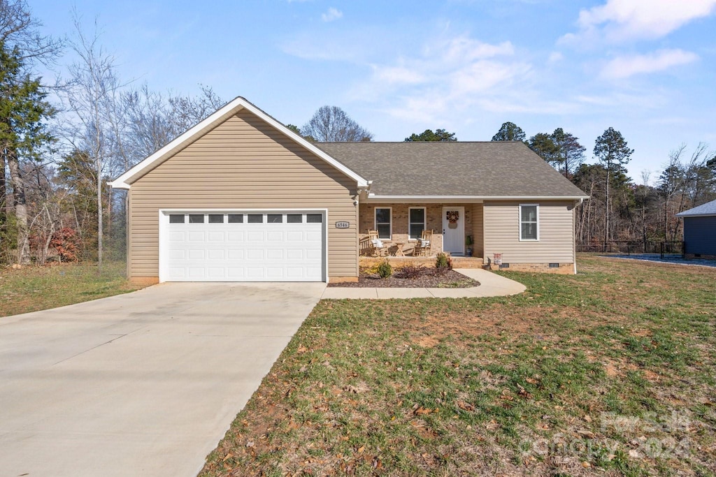 single story home featuring a porch, a garage, and a front lawn