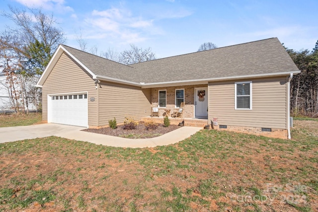 single story home with a garage, covered porch, and a front yard